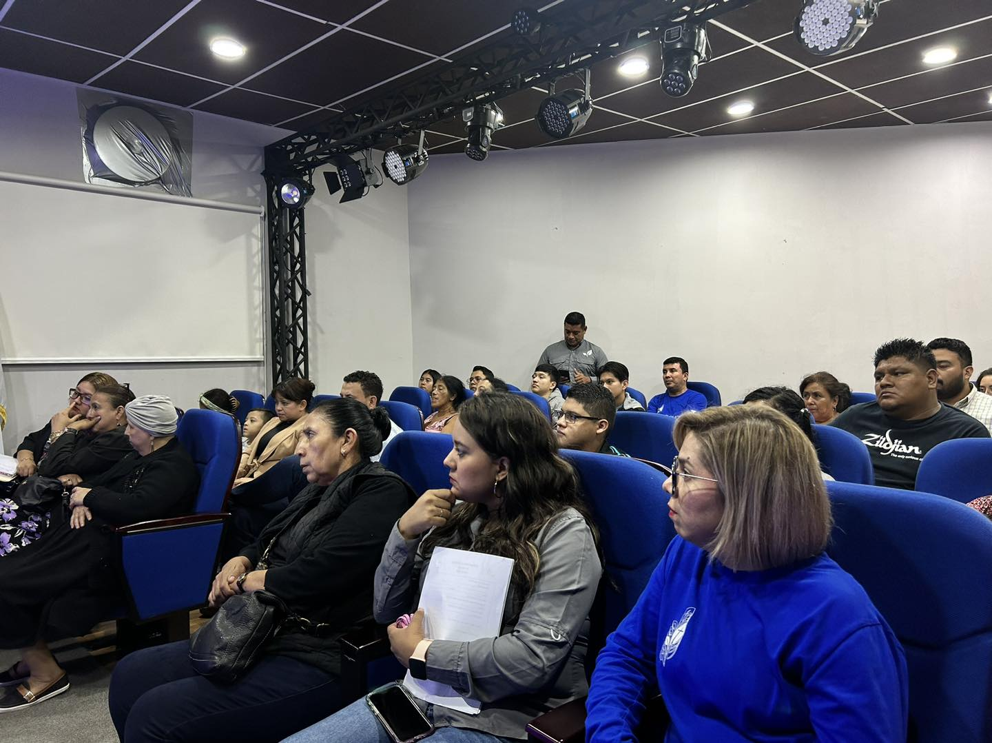 Audience using blue fixed auditorium seating