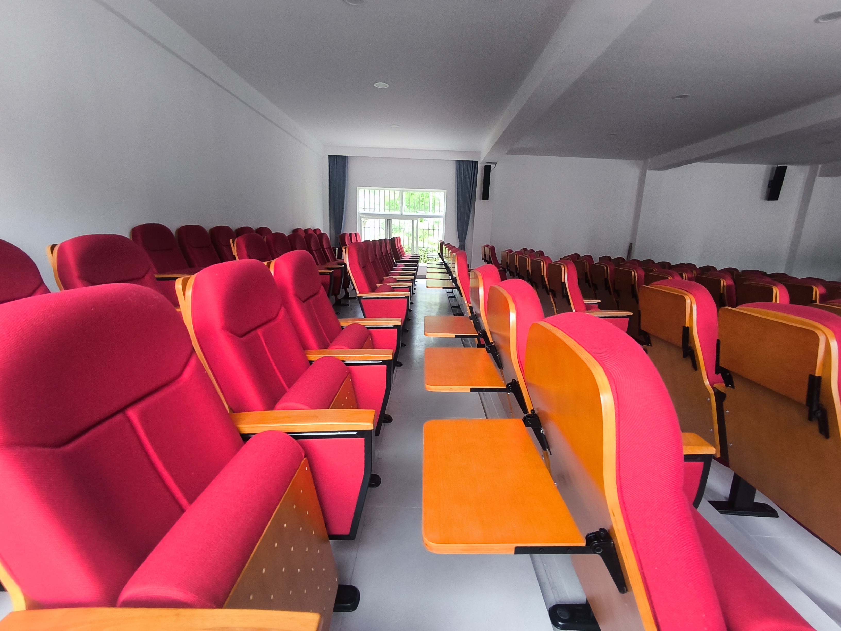Completed lecture hall seating with writing tablets
